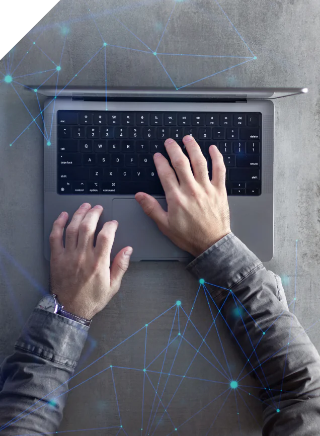 Hands typing on a laptop overlaid with a network visualisation